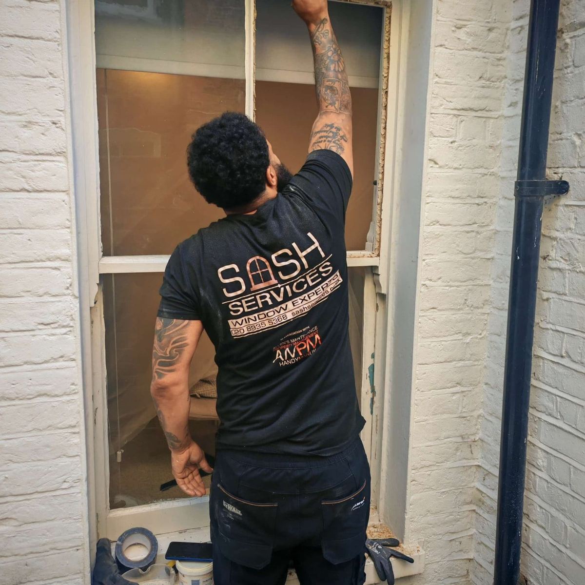 Joiner repairing a timber sash window